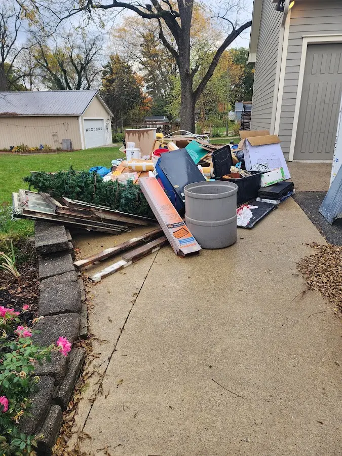 Dumpster being loaded with debris for 12 Yard Dumpster Rental in San Gabriel